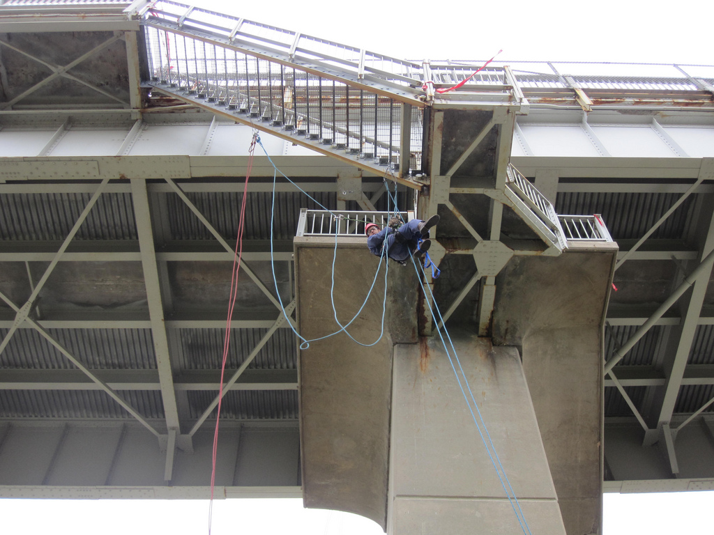A U.S. Army Corps of Engineers employee performing a bridge inspection.